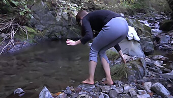 American College Student Trembles In River During Cold Winter